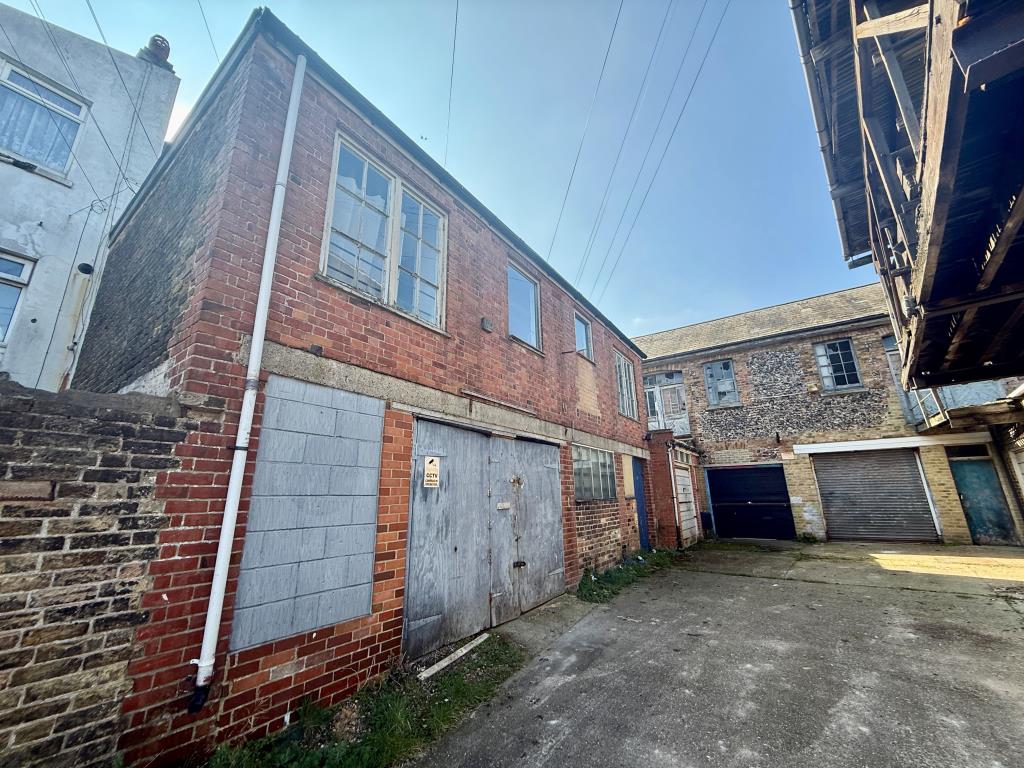 Lot: 162 - TOWN CENTRE BUILDERS YARD/WORKSHOPS WITH PLANNING FOR REDEVELOPMENT - Buildings to left